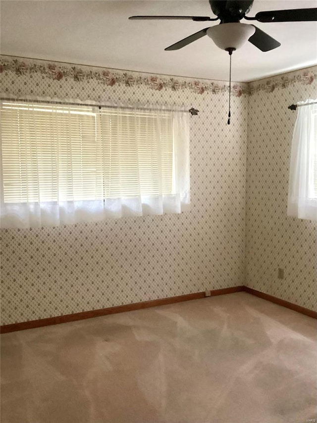 spare room featuring carpet floors and ceiling fan