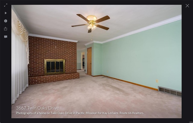 unfurnished living room featuring ornamental molding, a fireplace, carpet flooring, and ceiling fan