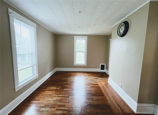 unfurnished room featuring crown molding and dark hardwood / wood-style floors