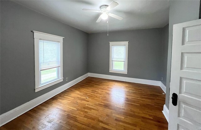 empty room featuring wood-type flooring and ceiling fan