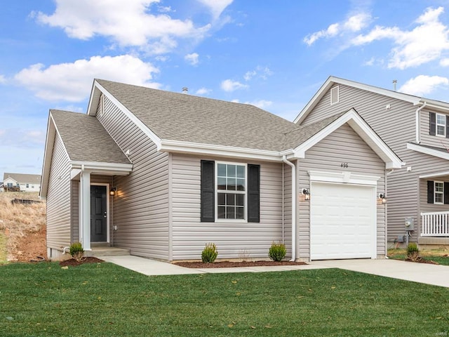 view of front of house featuring a front yard and a garage