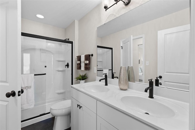 bathroom with vanity, toilet, tile patterned floors, and a shower with shower door