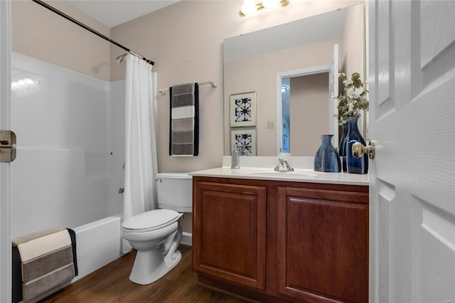 full bathroom with vanity, hardwood / wood-style floors, toilet, and shower / bath combo with shower curtain