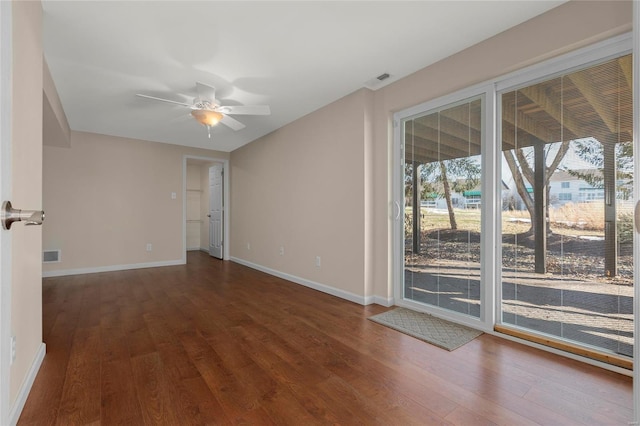 unfurnished room with dark hardwood / wood-style floors and ceiling fan