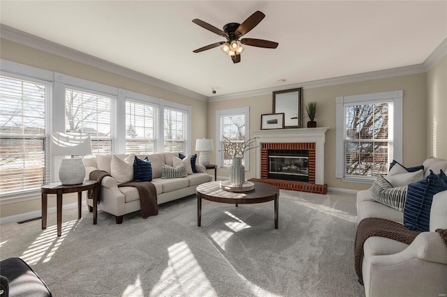 carpeted living room with ceiling fan, ornamental molding, and a brick fireplace