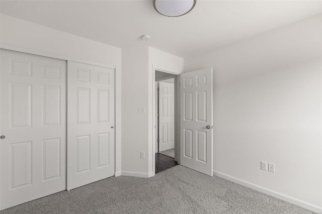 unfurnished bedroom with carpet and a closet