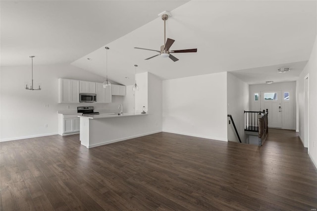 unfurnished living room with vaulted ceiling, dark wood-type flooring, baseboards, a sink, and ceiling fan