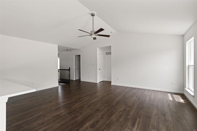 spare room with ceiling fan, vaulted ceiling, and dark hardwood / wood-style flooring