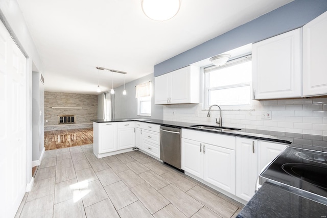 kitchen with pendant lighting, stainless steel appliances, sink, and white cabinets