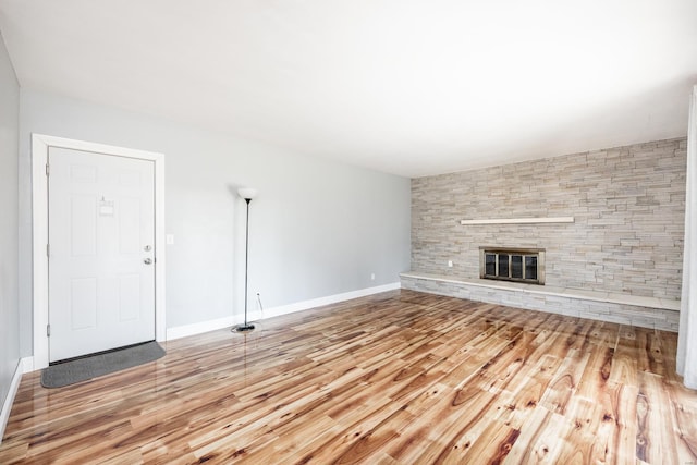 unfurnished living room with hardwood / wood-style floors and a fireplace