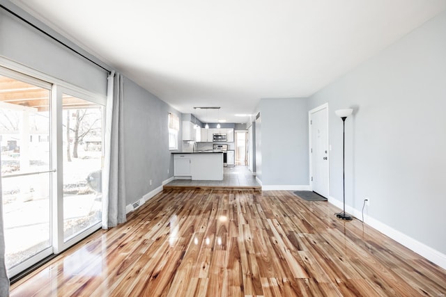 unfurnished living room featuring light wood-type flooring