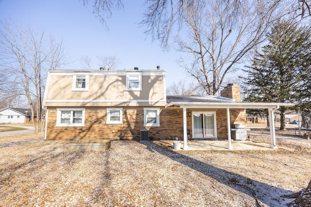 rear view of property with a patio area and central air condition unit