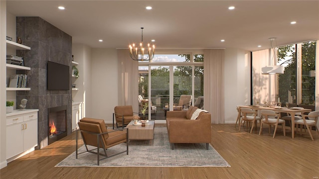 interior space featuring light wood-type flooring, a fireplace, and a notable chandelier