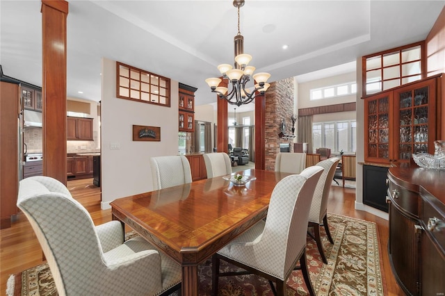 dining space with an inviting chandelier and light hardwood / wood-style floors