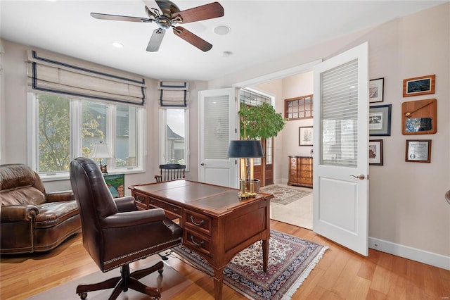 office space with light hardwood / wood-style floors and ceiling fan