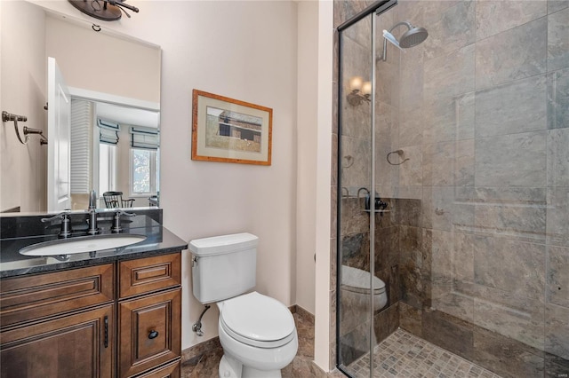 bathroom with vanity, toilet, and an enclosed shower