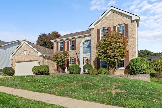 front facade with a front yard and a garage