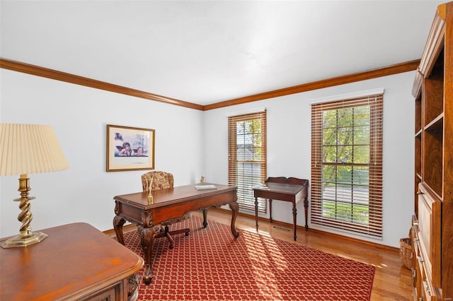 office with light hardwood / wood-style flooring and ornamental molding