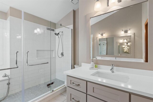 bathroom featuring tile patterned flooring, an enclosed shower, vaulted ceiling, and vanity