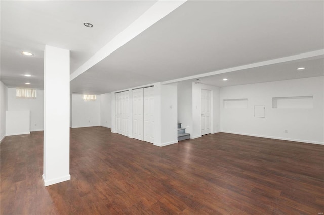 basement with dark hardwood / wood-style flooring