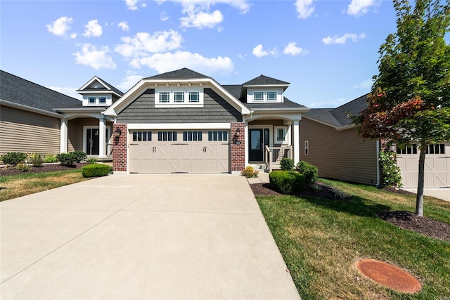 craftsman-style home with covered porch, a front yard, and a garage