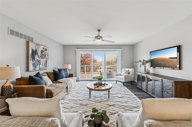 living room featuring dark hardwood / wood-style floors and ceiling fan