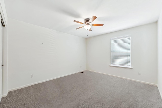 empty room with ceiling fan and carpet floors