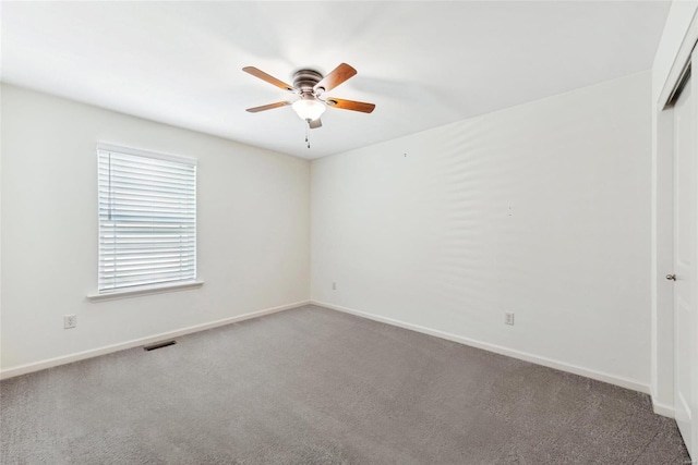 empty room featuring carpet floors and ceiling fan