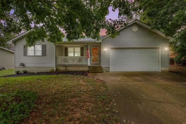 ranch-style home featuring covered porch and a garage