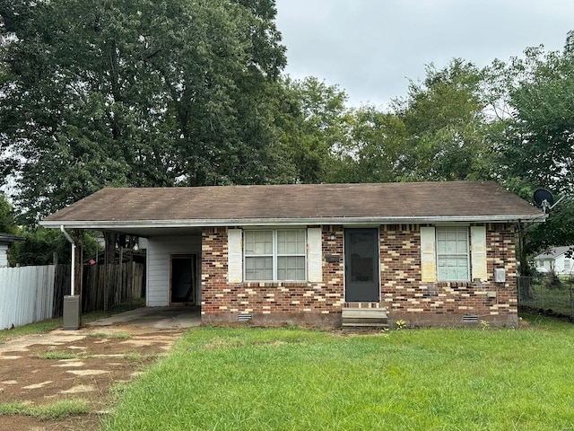 ranch-style home featuring a front yard and a carport