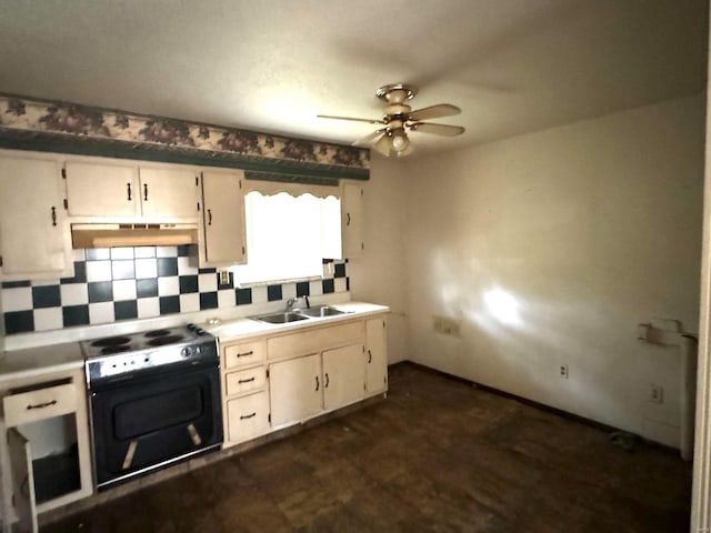 kitchen featuring tasteful backsplash, ventilation hood, black range with electric cooktop, ceiling fan, and sink