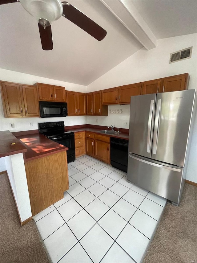 kitchen with ceiling fan, sink, lofted ceiling with beams, light tile patterned floors, and black appliances