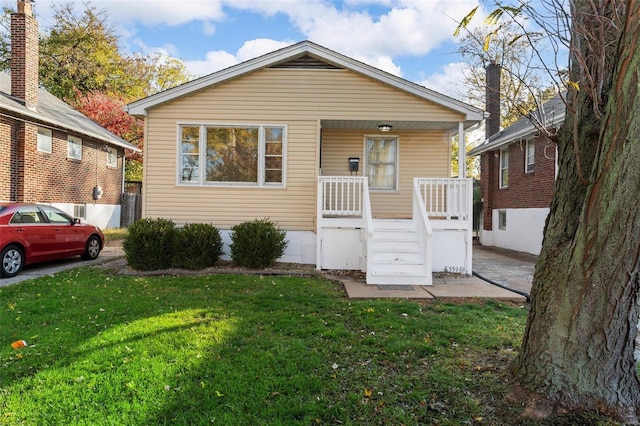 bungalow-style house featuring a front lawn and a porch