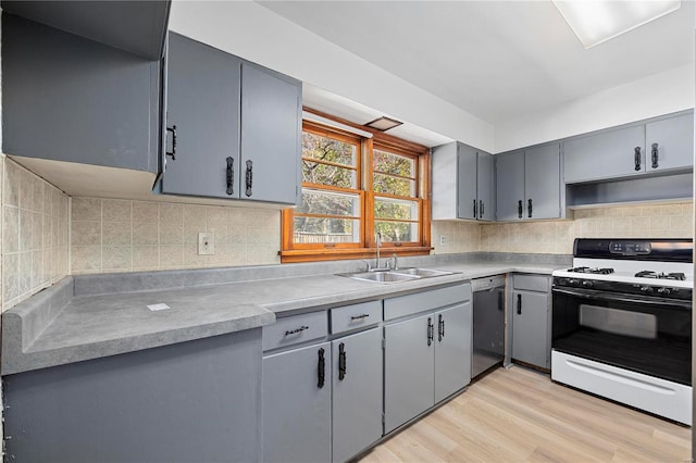 kitchen with backsplash, white range with gas cooktop, sink, light hardwood / wood-style flooring, and dishwasher