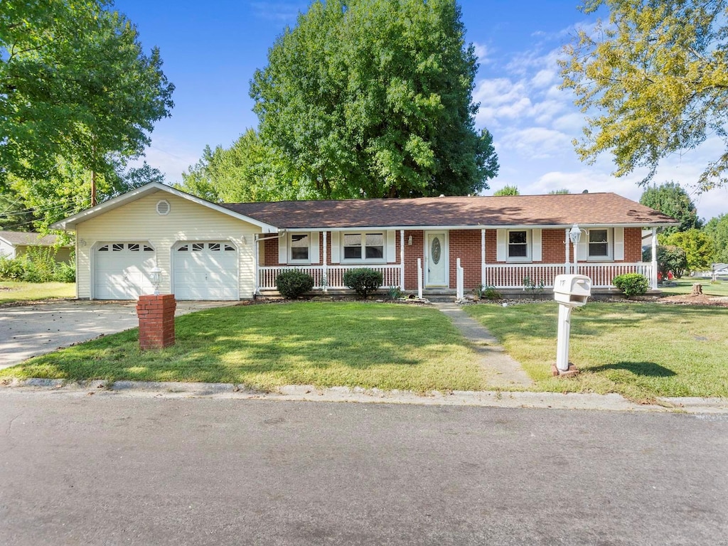 single story home with a garage, a front yard, and covered porch