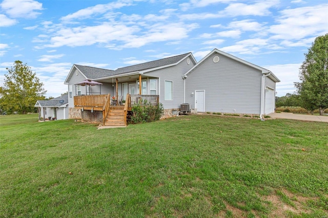 back of house featuring a wooden deck, central air condition unit, a lawn, and a garage