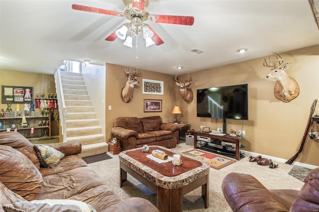 carpeted living room with ceiling fan