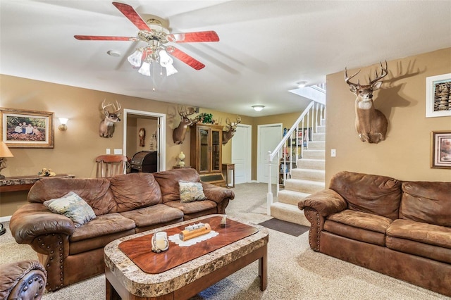 living room with ceiling fan and light colored carpet