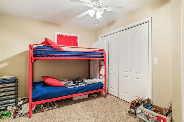 carpeted bedroom with a closet and ceiling fan