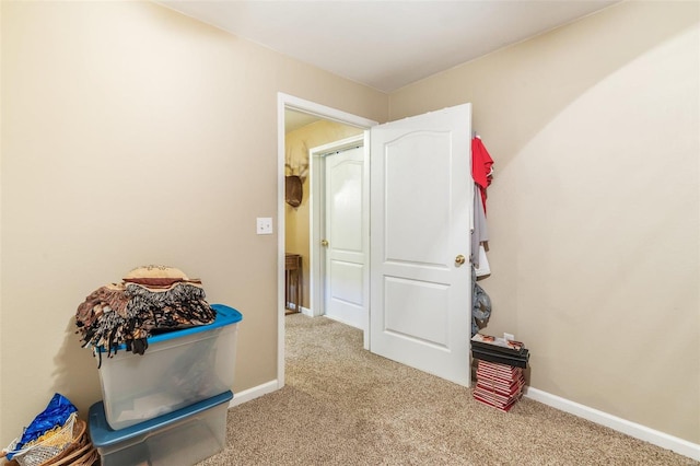 hallway with light colored carpet