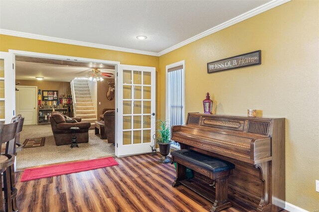 misc room featuring french doors, hardwood / wood-style flooring, and crown molding