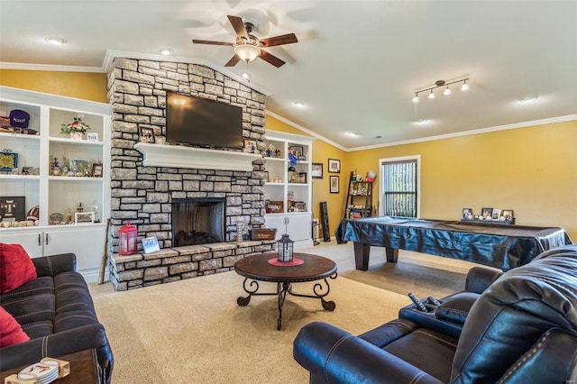 living room featuring lofted ceiling, ornamental molding, and a fireplace