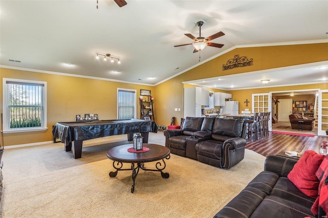 carpeted living room featuring crown molding, vaulted ceiling, and ceiling fan