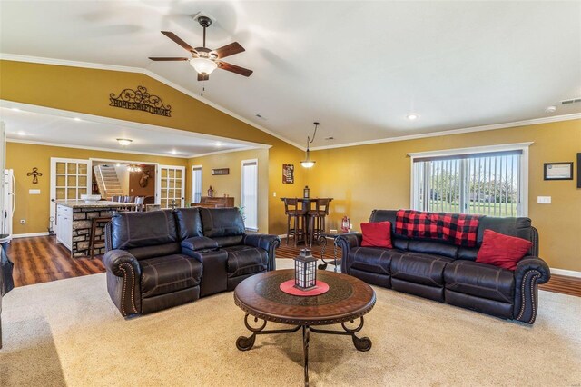 living room with ornamental molding, hardwood / wood-style flooring, ceiling fan, and vaulted ceiling