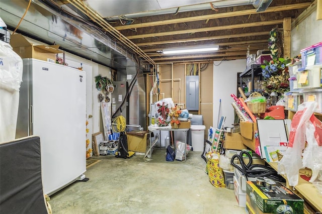 basement with electric panel and white refrigerator