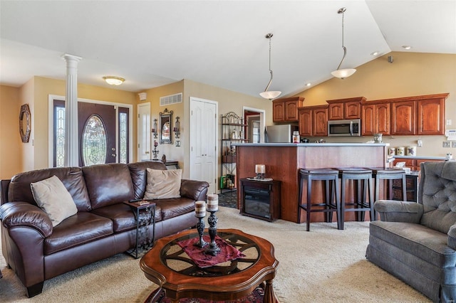 living room featuring light carpet, lofted ceiling, and ornate columns