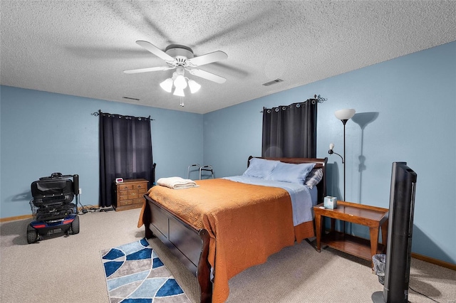 bedroom featuring ceiling fan, light colored carpet, and a textured ceiling