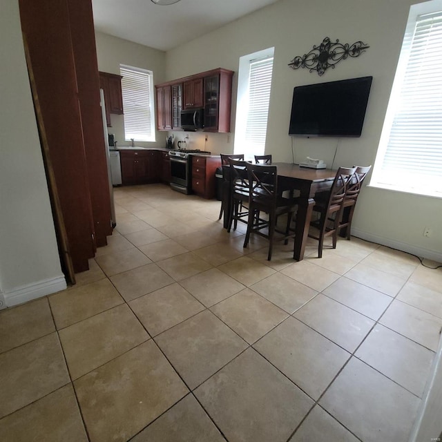 dining area featuring light tile patterned flooring and sink