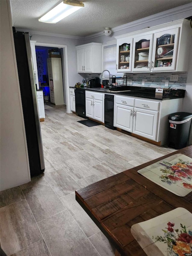 kitchen featuring white cabinetry, tasteful backsplash, dishwasher, a textured ceiling, and ornamental molding