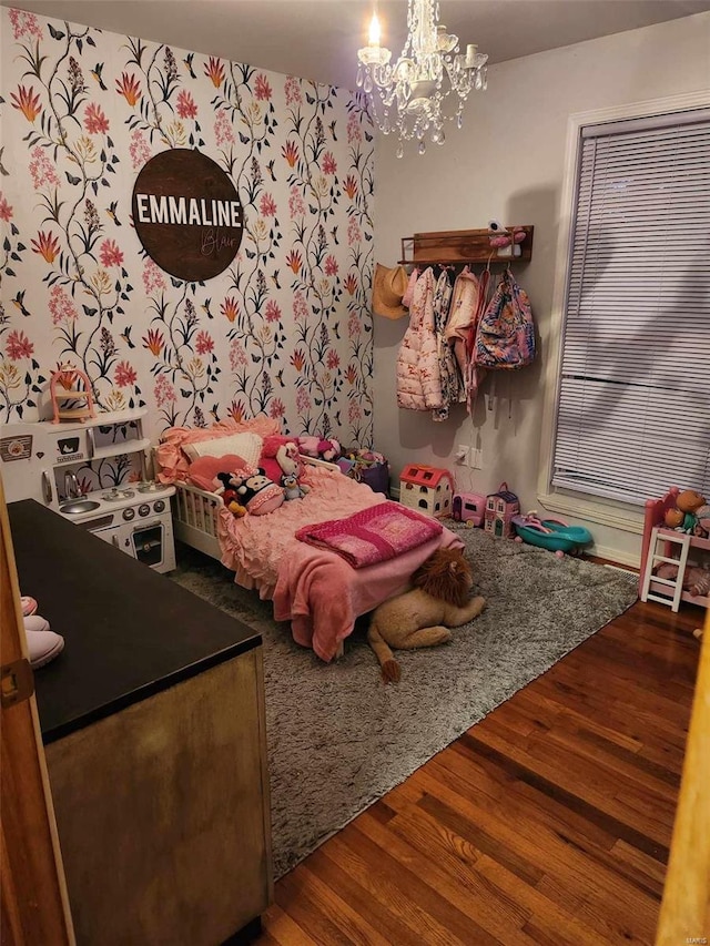 bedroom featuring wood-type flooring and a notable chandelier